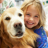child in hospital with golden retriever